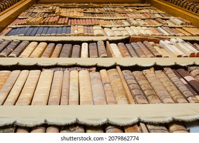 Tall Bookcase With Very Old Editions And Aged Covers