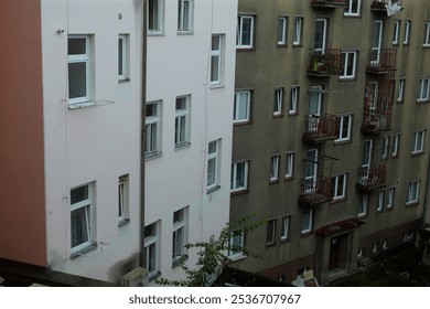 A tall building that prominently features a fire escape located on the side of the structure, providing safety and access in emergencies - Powered by Shutterstock