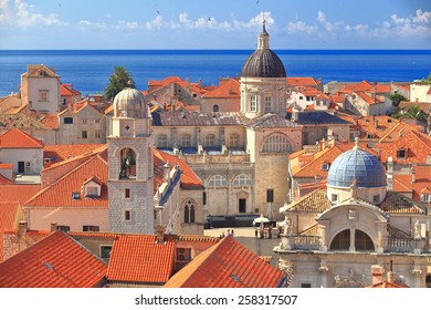 Tall Church Domes And The Medieval Clock Tower Above Roof Tops Inside Dubrovnik Old Town, Croatia