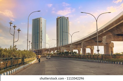 Tall City Buildings With Under Construction Over Bridge Alongside Highway Road At Rajarhat, Kolkata India.