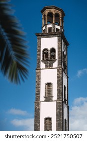 A tall colonial tower with a clock on it