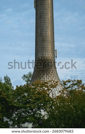 Tall concrete tower structure with tiled surface