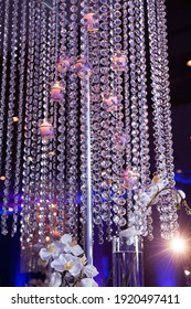 Tall Crystal centerpiece with glowing illuminated candles set on table for private luxury wedding event at hotel