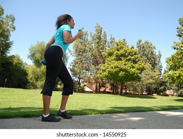 Tall Fit Young Woman Power Walking In The Park