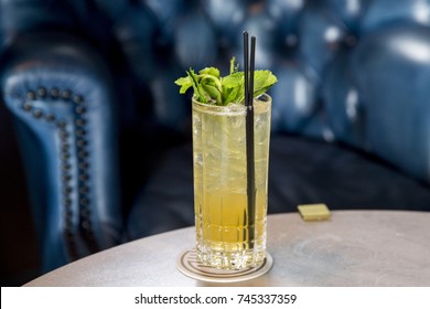 Tall Glass Of Lemonade Spritzer With Ice And Fresh Green Mint And Straw