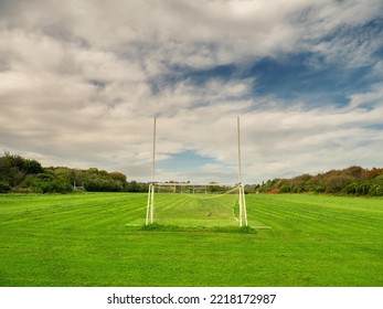 Tall Goal Post On Training Pitch For Irish National Sport Camogie, Hurling, Rugby And Gaelic Football Nobody. Cloudy Sky. Popular Activity.