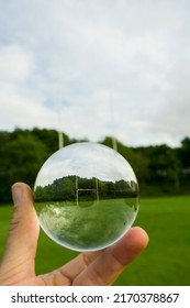 Tall goal post for rugby, hurling and camogie training in glass ball. Popular active game in Ireland. National sport. Park with sport field. Low angle shot.