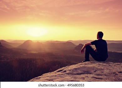 Tall hiker in mountains. Thinking man silhouette in nature within daybreak. The vignetting effect.