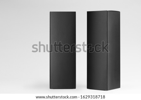 Tall large black blank rectangle paper boxes side and front view on white background, mock up of packing, branding product, advertising, design.