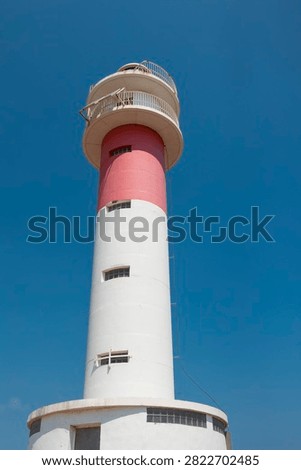 Tall lighthouse tower providing navigation and guidance along the coast