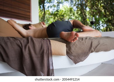 Tall Man Sleeping On Couch Bed At Terrace Garden