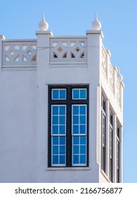 Tall Narrow Windows Near Decorative Top Corner Of Whitewashed Concrete House In New Urbanist Architectural Style In A Beach Town On A Sunny Afternoon Along The Gulf Coast In Northwest Florida