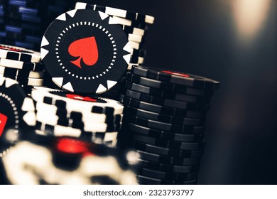 Tall Pile Of Black And White Casino Poker Chips With Red Spade Symbol. 