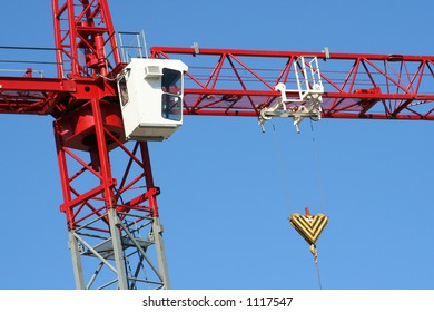 Tall Red and White Construction Crane with Blue Sky