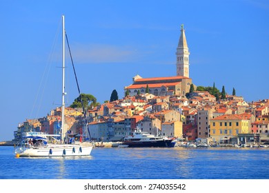 Tall sail boat enters the harbor of old Venetian town of Rovinj, Croatia