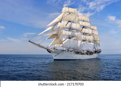 Tall Ship under sail with the shore in the background - Powered by Shutterstock