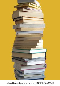 A Tall Stack Of Many Books Piled High, Isolated On Yellow