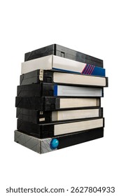 A tall stack of old VHS video tapes with worn labels and cases, isolated on white background.
