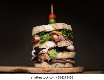 Tall Stacked Meat Sandwich On A Black Background