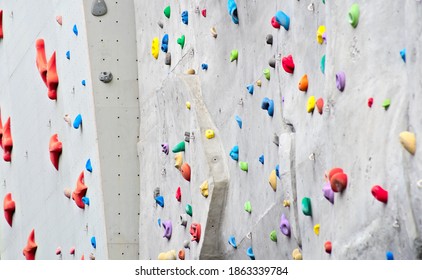 
A tall and steep climbing wall with many colorful handles. - Powered by Shutterstock