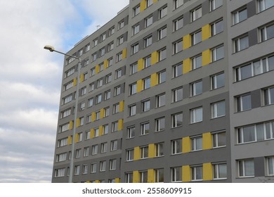 A tall structure that features numerous windows and has a street light positioned right in front of it, illuminating the area below