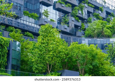 Tall structures adorned with greenery create a striking contrast against the urban skyline, showcasing nature's beauty intertwined with innovative design during a sunny afternoon.
