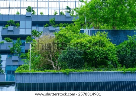 Tall structures adorned with greenery create a striking contrast against the urban skyline, showcasing nature's beauty intertwined with innovative design during a sunny afternoon.