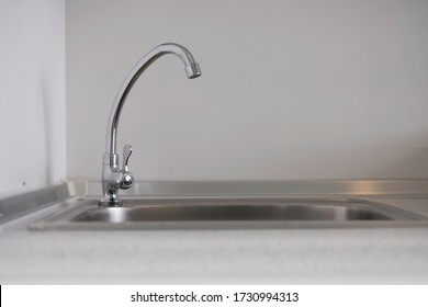 Tall Water Lavatory Faucet On Kitchen Sink In Condo. No Water Running Out From Faucet / Tap Into Kitchen' S Sink As Owner Want To Save Nature. Tap Water And Water Conservation Concept. Copy Space.