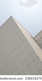 tall white building with a rectangular pattern
