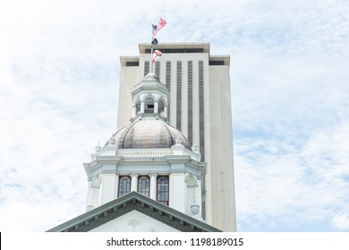 Tallahassee, USA - April 26, 2018: Exterior state capitol building in Florida during sunny day with modern architecture of government, flags