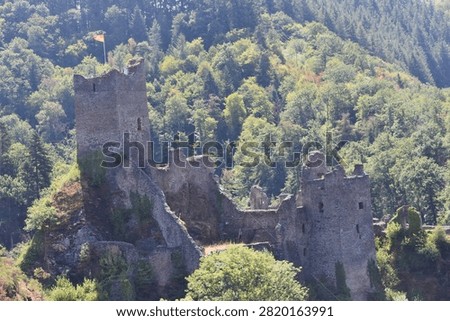 The tallest tower dominates the ruins, while scattered walls hint at the once-impressive medieval stronghold that guarded this strategic borderland.