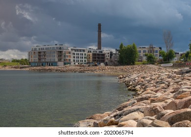 Tallinn, Estonia - August 01 2021: Tallinn Cityscape. View Of Kalaranna District And New Apartment Buildings. Baltic Sea And Big Stones In The Foreground.