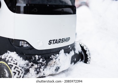 Tallinn, Estonia - December 4, 2021: Starship Technologies Autonomous Drone Vehicle Moving In Snow During Winter. Starship Self Driving Contactless Food Delivery Robot.