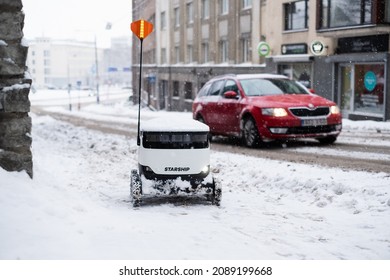 Tallinn, Estonia - December 4, 2021: Starship Technologies Autonomous Drone Vehicle Stuck In Snow In Winter. Starship Self Driving Contactless Food Delivery Robot.