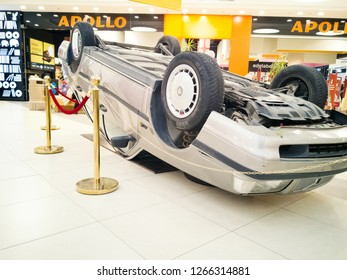 TALLINN, ESTONIA - DETSEMBER 16, 2018: Volvo Turned Upside-down After Road Collision In Kristiine Shopping Centre. Old  Overturned Car Accident Scene Upside Down On Shop Floor. Copy Space For Text Box