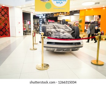 TALLINN, ESTONIA - DETSEMBER 16, 2018: Volvo Turned Upside-down After Road Collision In Kristiine Shopping Centre. Old  Overturned Car Accident Scene Upside Down On Shop Floor. Copy Space For Text Box