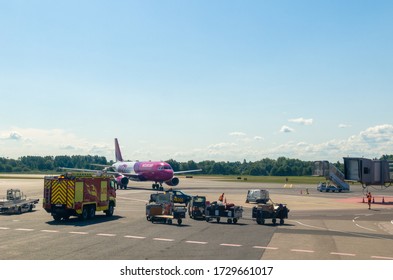 Tallinn, Estonia - July 19, 2019: _ A Wizz Air Plane, Which Is A Hungarian Low-cost Airline, At  Tallinn Airport Surrounded By Emergency Vehicles