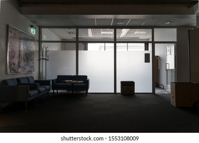 Tallinn / Estonia - November 07 2019:  Office During Business Run Down Process. Empty Dark Cubicles And Cabinets, Old Furniture, White Grey Walls That Gives Sad Feeling. Employees Dismissed.