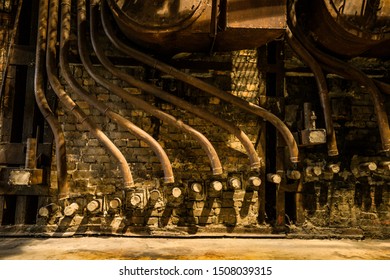 Tallinn / Estonia - September 18 2019: An Industrial-looking Historic Building Which Is Creative Hub Today. Old Wall Full Of Rusty Constructions From Pre-war Period Power Plant Boiler Room.  