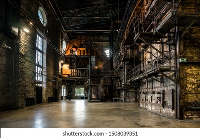 Tallinn / Estonia - September 18 2019: An Industrial-looking Historic Building Which Is Creative Hub Today. Old Wall Full Of Rusty Constructions From Pre-war Period Power Plant Boiler Room.  