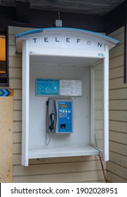 Tallinn Estonia-01.22.21: Old Retro Looking Pay Phone Booth. Nicely Restored Still Usable Coin Operated Phone In Public. One Of The Last One Standing In Estonia. Located In Estonian Open Air Museum