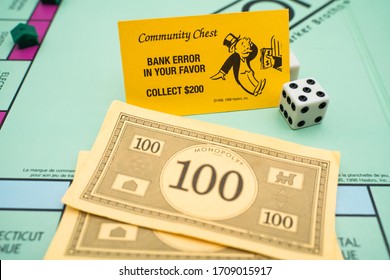 Tallinn/Estonia-04.11.2020: Monopoly Board Game. Family Fun Activity During Corona Outbreak. Bank Error In Your Favor 200$. Community Chest Card. Yellow Monopoly Card. Dice In Corner.