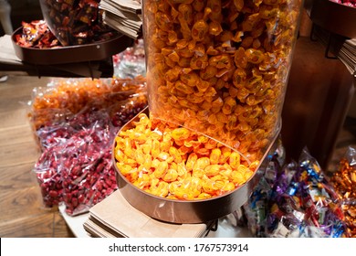 Tallinn/Estonia-06.04.2020: Candy Dispenser. Kalev Candy Store In Rotermann District. Orange Lollies In The Stall. Lots Of Candies. Sweet Tooths Dream. Sugar Overdose. Kids Favaorite Shop