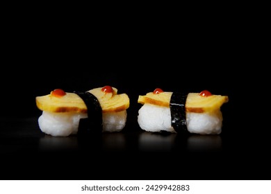 Tamago Nigiri served on a black wooden plate, avocado, cucumber, lump crab meat, sushi menu, social media post, food photography, fine dining, Japanese food, purple background - Powered by Shutterstock