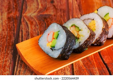 Tamagoyaki Maki With Seaweed Wrap On Wooden Tray. Delicious Japaneses Food.