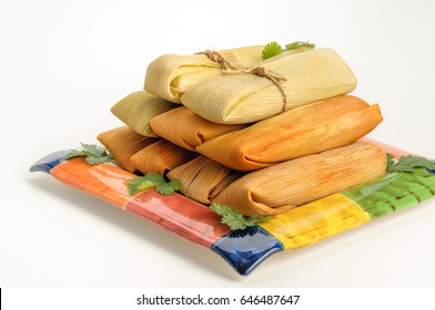 Tamales, Mexican dish made with corn dough, chicken and chili, wrapped with a corn leaf