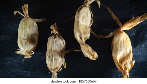 Tamales In An Overhead Shot On A Dark Table