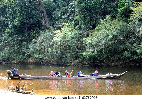 Taman Negara National Park, Malaysia -\
 February,\
19, 2018 - Muslim Malaysian women and kids riding a boat in Taman\
Negara National Park
