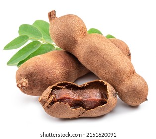 Tamarind Fruits And One Cracked Tamarind With Brown Pulp In The Foreground Isolated On White.