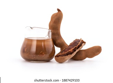 Tamarind Fruits And Tamarind Pulp Mixed Water In The Glass Isolated On White Background.